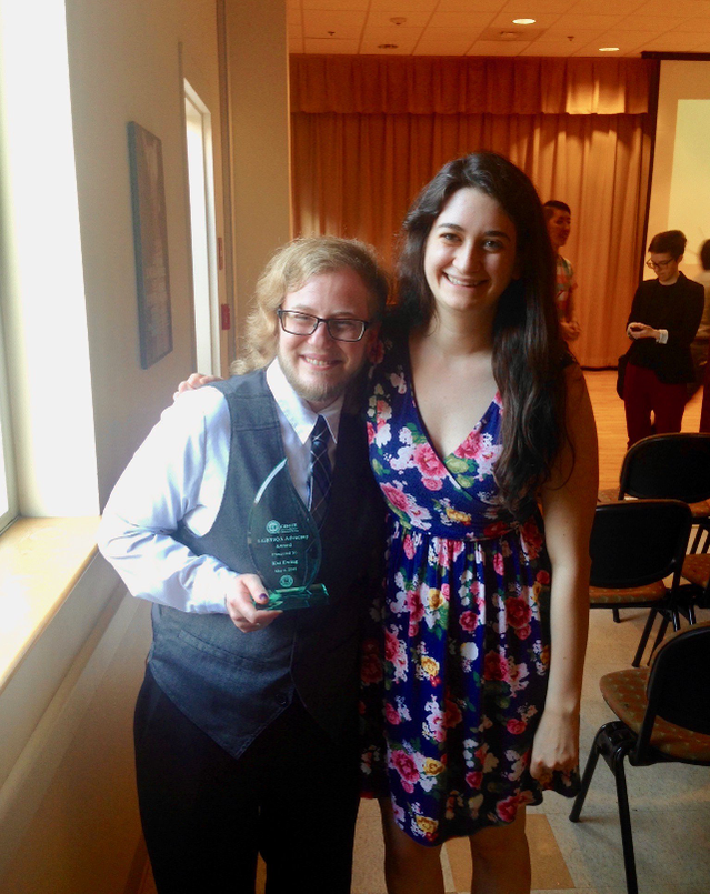 Picture of me and Cait Kennedy with me holding my advocacy award. Award is water-droplet shaped and transparent.