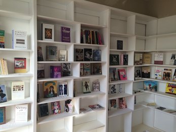 White shelves with books.
